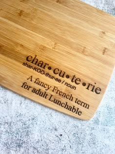 a chopping board with the words charcuterie on it and an image of a french term for adult lunchables