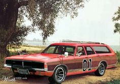 an old red station wagon is parked on the side of a dirt road near a tree