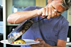 a man is cutting up food on a plate