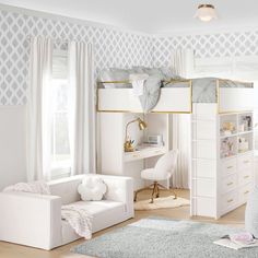 a child's bedroom with bunk beds, desk and chair in the middle of it