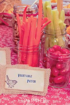 carrots, celery, and pickles are on display in mason jars