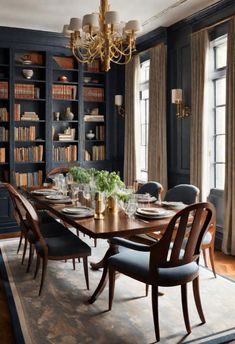 a dining room table with chairs and bookshelves