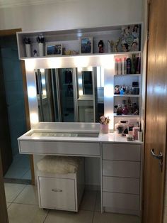 a bathroom vanity with lighted mirror and stool