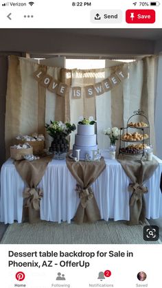 a table topped with a cake next to a window covered in burlap ribbon