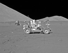 an image of astronauts on the moon with rovers in the background and earth behind them