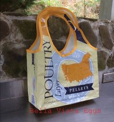 a grocery bag sitting on the ground next to a stone wall with an advertisement for pellet's