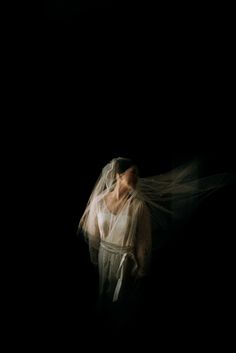 a woman wearing a veil in the dark