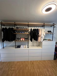 an empty room with shoes and clothes on shelves