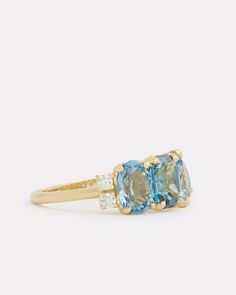 18K Yellow Gold Cluster Ring with Sky Blue Topaz, London Blue Topaz, Aquamarine and Diamonds, .2 TCWOrnament is 7/8 Inch x 3/8 Inch Style# YRCOCPBW Luxury Blue Topaz Cushion Cut Ring, Blue Topaz Three Stone Blue Jewelry, Yellow Gold Blue Topaz Baguette Cut Ring, Yellow Gold Baguette Cut Blue Topaz Ring, Blue Topaz Baguette Cut Ring In Yellow Gold, Baguette Cut Blue Topaz Ring In Yellow Gold, Luxury Blue Cushion Cut Topaz Ring, Luxury Three Stone Topaz Ring For Wedding, Luxury Three-stone Topaz Wedding Ring