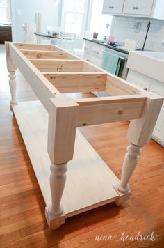 a kitchen island made out of plywood is shown in the middle of a hardwood floor