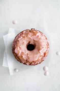 a frosted donut sitting on top of a white napkin