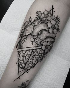 a black and white photo of a heart with flowers on it's side arm