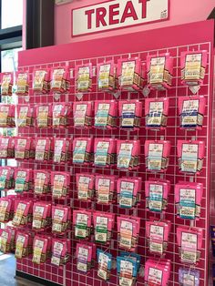 there is a pink display with many different items on it