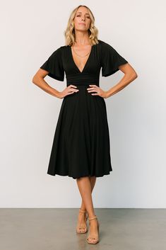 Classic black color Stretchy material Deep V-neckline Short sleeves Gathered waist accent Smocked at back waistline Midi-length flare skirt 90% Polyester, 10% Spandex Trina is 5'6, cup size 32C, size 2 and is wearing size S Perfect Little Black Dress, Midi Dress Black, Cup Size, Black Midi Dress, Flare Skirt, Stretchy Material, Midi Length, Snug Fit, Classic Black