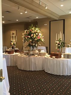 there is a banquet table with flowers on it