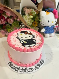 there is a hello kitty cake on the table