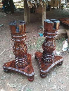 two wooden candlesticks sitting next to each other