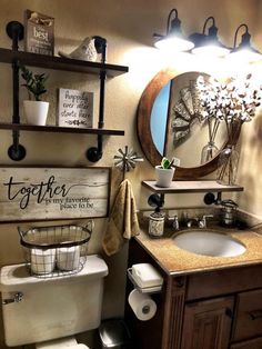 a bathroom with a toilet, sink and shelves on the wall next to a mirror