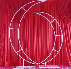 an image of a stage set with red curtains and white stand on the bottom floor