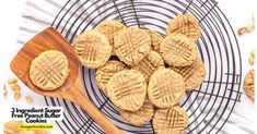 peanut butter cookies on a wire rack with a wooden spoon