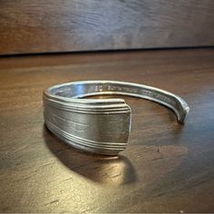 a silver ring sitting on top of a wooden table