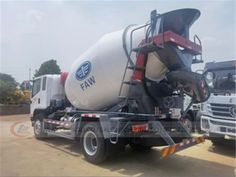 a white cement truck parked in a parking lot