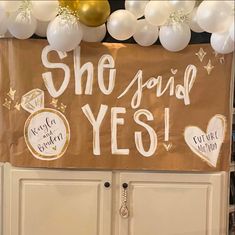 there is a sign that says she found yes on the side of a door with balloons around it