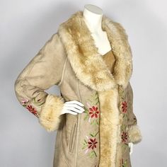 Beautiful long vintage Afghan sheephide coat in fine suede, also known as 1960's penny lane coat. The front, the collar and the cuffs are set with soft faux fur. The inside of the coat is completely lined with long-haired faux fur, making the coat extra warm and comfortable to wear. This coat is decorated with floral embroideries. This coat has 2 side pockets. The coat can be closed with 3 hooks. If needed, more hooks can be easily made on by yourself. Important: this is a vintage coat on which Vintage Long-sleeved Faux Fur Coat, Vintage Long Sleeve Fur Coat With Faux Fur Lining, Vintage Long Coat In Faux Fur, Vintage Fur Coat With Faux Fur Lining For Fall, Vintage Faux Fur Trim Coat For Fall, Vintage Faux Fur Lined Outerwear, Vintage Spring Outerwear With Faux Fur Trim, Vintage Faux Fur Outerwear With Fur Trim, Vintage Fur Coat With Faux Fur Lining For Spring