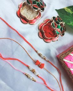 three different types of necklaces sitting next to each other on a white tablecloth