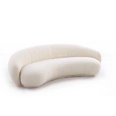 an oval shaped pillow sitting on top of a white surface