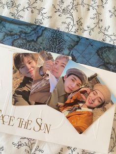 an envelope with photos of people on it and the words face the sun written in gold