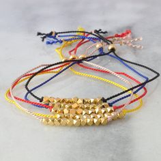 "Minimalism at its very best: our simple gold bead string bracelets -- available in 5 different colors -- will remind you that good things come in small packages. + 22K gold-plated diamond-cut beads + available in Blush, Black, Sunshine, Red and Indigo + durable silk cord + gold-filled finishing crimps + adjustable up to 9.5\" + all Libby & Smee beaded bracelets come packaged on a logo card in a clear resealing bag for storage and gift giving + to keep your jewelry looking new, avoid water, loti Gold Beaded Minimalist Friendship Bracelets, Gold Minimalist Friendship Bracelets With Round Beads, Gold Friendship Bracelets With Faceted Round Beads, Adjustable Gold Friendship Bracelets With Colorful Beads, Gold Friendship Bracelets For Jewelry Making With Colorful Beads, Gold Braided Bracelets With Tiny Beads For Friendship, Gold Braided Friendship Bracelets With Tiny Beads, Everyday Gold Beaded Braided Bracelets, Gold Beaded Minimalist Braided Bracelet