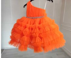 Make her special day unforgettable with our Orange One Shoulder Girl Dress! Whether she's celebrating a birthday, acting as a flower girl, or participating in a wedding as a junior bridesmaid, this dress is sure to make her feel like a princess. The one-shoulder design adds a touch of elegance, while the vibrant orange color makes a bold statement. The dress is crafted from high-quality materials, ensuring comfort and style all day long. Perfect for proms, weddings, or any special occasion, this dress is a must-have for your little one's wardrobe. Order now and let her shine! Dress Baby Girl, Baby Gown, Dress Flower, Bridesmaid Wedding, Birthday Dress, Junior Bridesmaid, Dress Prom