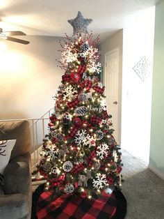 a christmas tree decorated with red, white and black ornaments