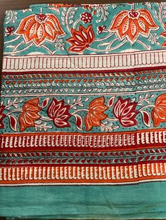 "Colorful, woodblock printed, cotton sarong, perfect for a day by the shore or to lounge in comfort at home. Wrap it in a variety of ways, as a beach dress (see photo), or around the waist, or simply use it to lie on at the beach. A versatile addition to any wardrobe! Measures 44\" x 72\"(180cm x110cm ) *Made of 100% cotton. *Hand Block printed *Machine wash on warm/cold *Production Capacity: 1000 Naturally occurring dye variations are found on all hand printed textiles, making each piece unique Traditional Printed Cotton Saree, Multicolor Cotton Sarong With Block Print, Multicolor Cotton Block Print Sarong, Traditional Hand Printed Cotton Scarves, Cotton Block Print Patterned Dupatta, Patterned Cotton Dupatta With Block Print, Bohemian Cotton Dupatta With Hand Print, Bohemian Cotton Dupatta Hand Printed, Traditional Block Print Pattern Cotton Fabric