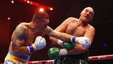 two men standing next to each other in a boxing ring