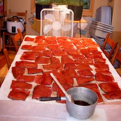 the table is covered with raw fish and ready to be put into the oven for cooking