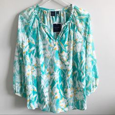 Turquoise Floral Top Fabric: 100% Polyester Care: Machine Washable Turquoise Floral Print Top For Spring, Casual Turquoise Beach Blouse, Casual Turquoise V-neck Blouse, Casual Turquoise Top For Spring, Floral Print Tunic, Blue Floral Top, Black Blouse Long Sleeve, Printed Sleeveless Blouse, Dressy Blouse