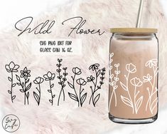 a glass jar with flowers drawn on it and the words wild flower next to it