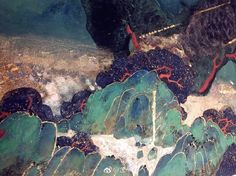 an abstract painting with blue and green colors on the bottom half of it, surrounded by rocks