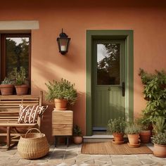 a porch with potted plants on the side and a bench in front of it