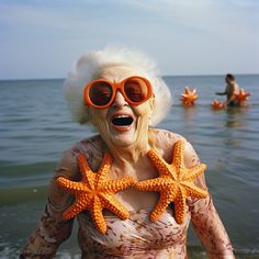 an older woman wearing sunglasses and starfish decorations in the water with people swimming in the background