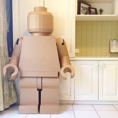 there is a cardboard robot standing in the kitchen