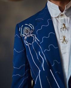 The Floating Spider | Jatin Malik Introducing our Blazer Set inspired by Dali’s infamous painting - "Spider of the Evening 1940". Delicately embroidered with ivory cross and chain stitches, this ensemble weaves a tale of mystery and sophistication. Its unique patchwork, contrasting against its deep base color, echoes the enigmatic charm of the night, inviting you to embrace a world of unparalleled elegance. Paired with a white shirt and matching tapered trousers, this ensemble offers a refined and polished look that is perfect for making a statement at any formal occasion or special event. Step into the realm of art and elegance with this captivating ensemble, designed to capture attention and leave a lasting impression. Included in purchase: Blazer, Shirt, Trousers Product Specification C Jatin Malik, Blouse Yoke, Personal Shopping Service, Dhoti Pants, Blazer Set, Blazer Shirt, Tapered Trousers, Indian Wedding Outfits, Dali