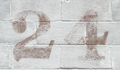 a brick wall with the number twenty two painted on it