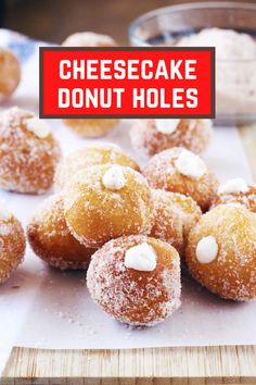 some donuts are sitting on top of a cutting board with the words cheesecake donut holes