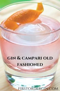 gin and campari old fashioned cocktail in a glass with an orange garnish