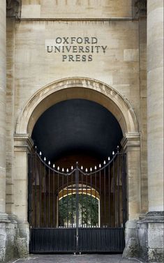 an entrance to the oxford university press building with wrought iron gates and arched doorways