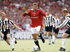 a group of men playing soccer against each other