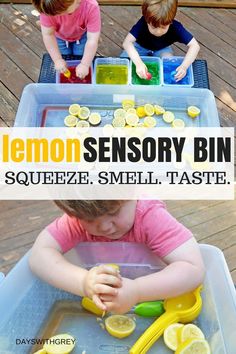 two children are playing with lemons in a bin